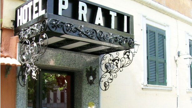 A hotel entrance with a sign reading "HOTEL PRATI".