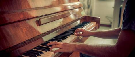 A person playing a Hupfeld upright piano.