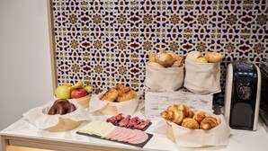 A breakfast buffet with various pastries, bread, and meats. - U-Sense Sevilla Centro (Seville)