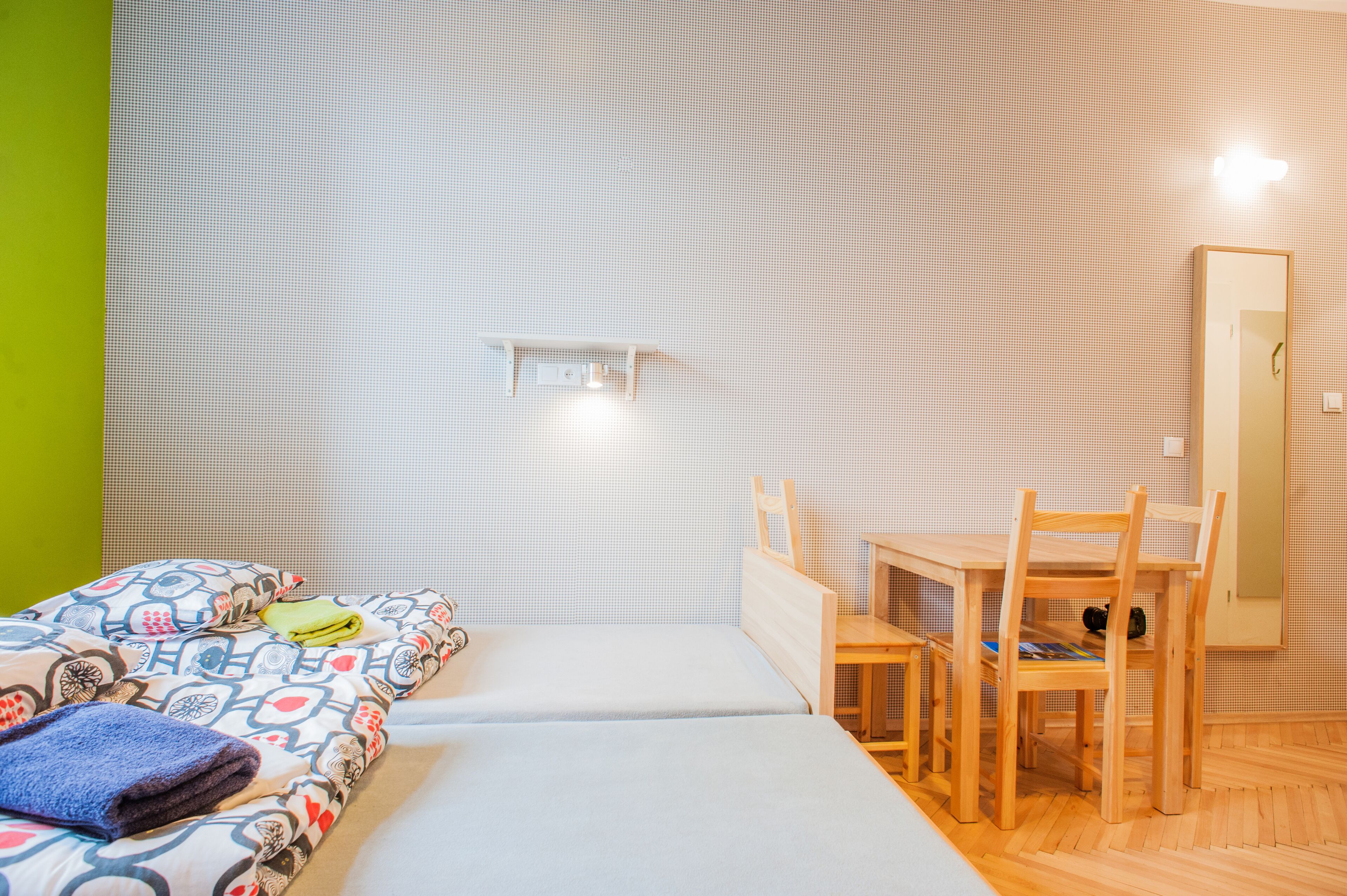 A room with a bed, a desk, and a chair.