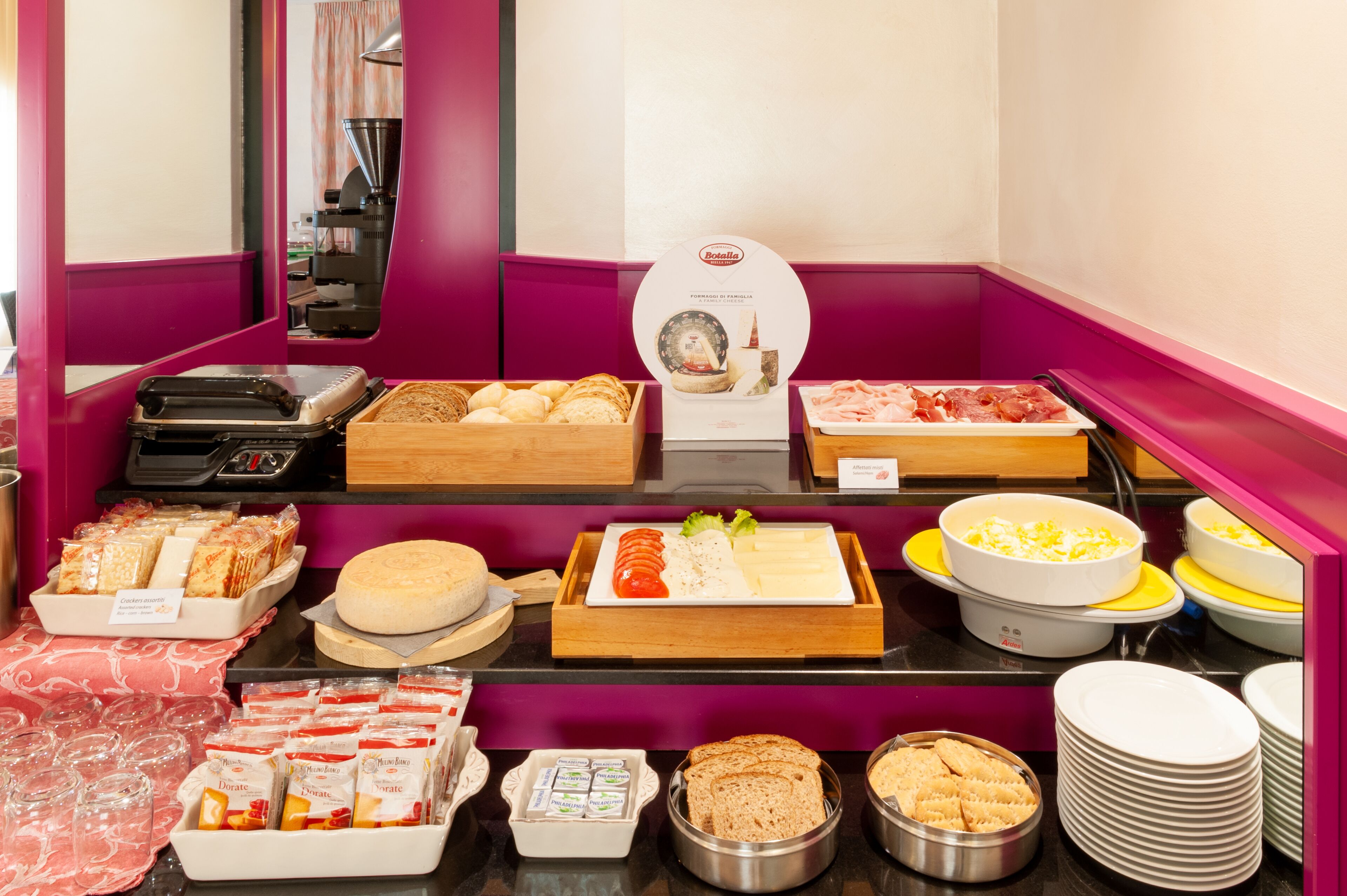 A buffet with various food items including bread, cheese, and meats.