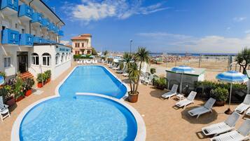 On the beach, beach shuttle, sun-loungers, beach umbrellas
