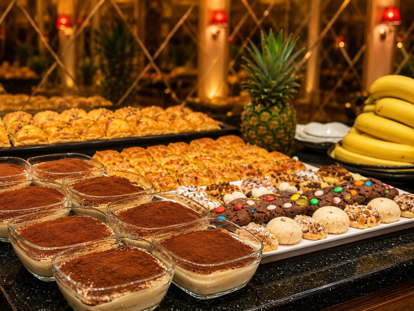 A buffet with various desserts, including tiramisu, pastries, and cookies.