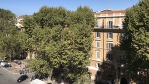 A multi-story building with a red-tiled roof and a balcony. - Il Tesoro (Rome)