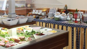 A buffet setup with various food items and beverages.