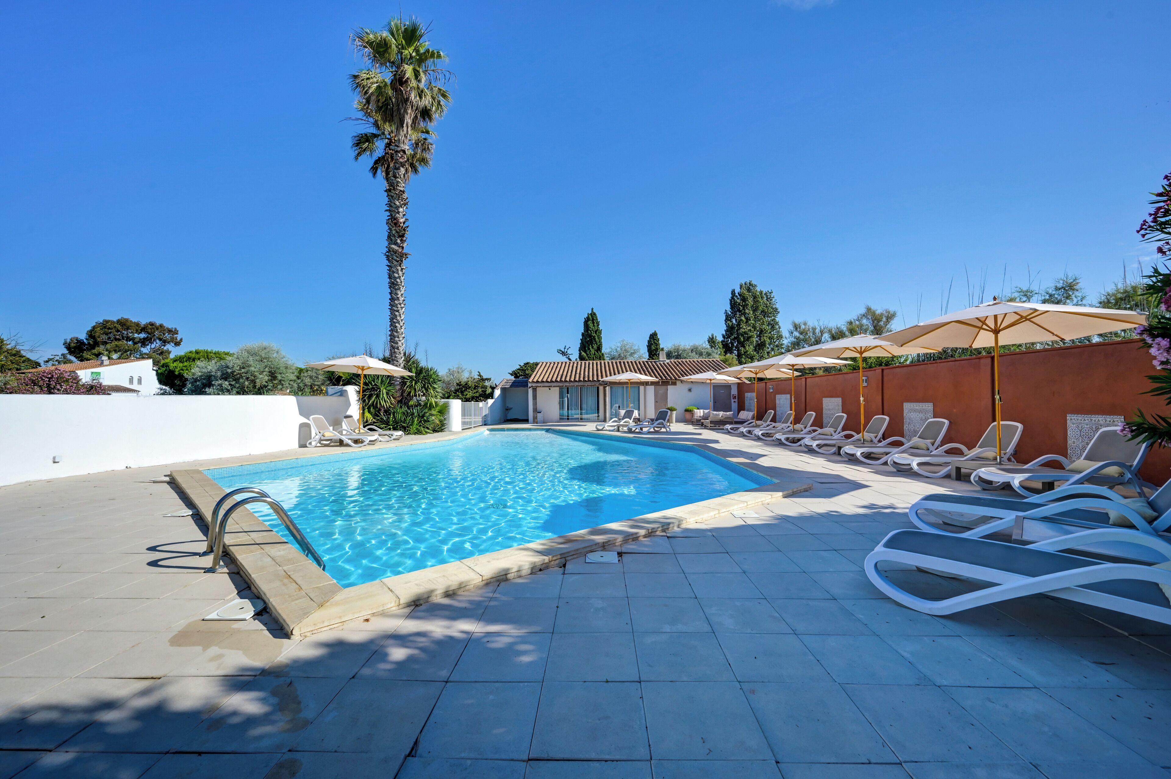 Seasonal outdoor pool, open 10:00 AM to 7:30 PM, pool umbrellas