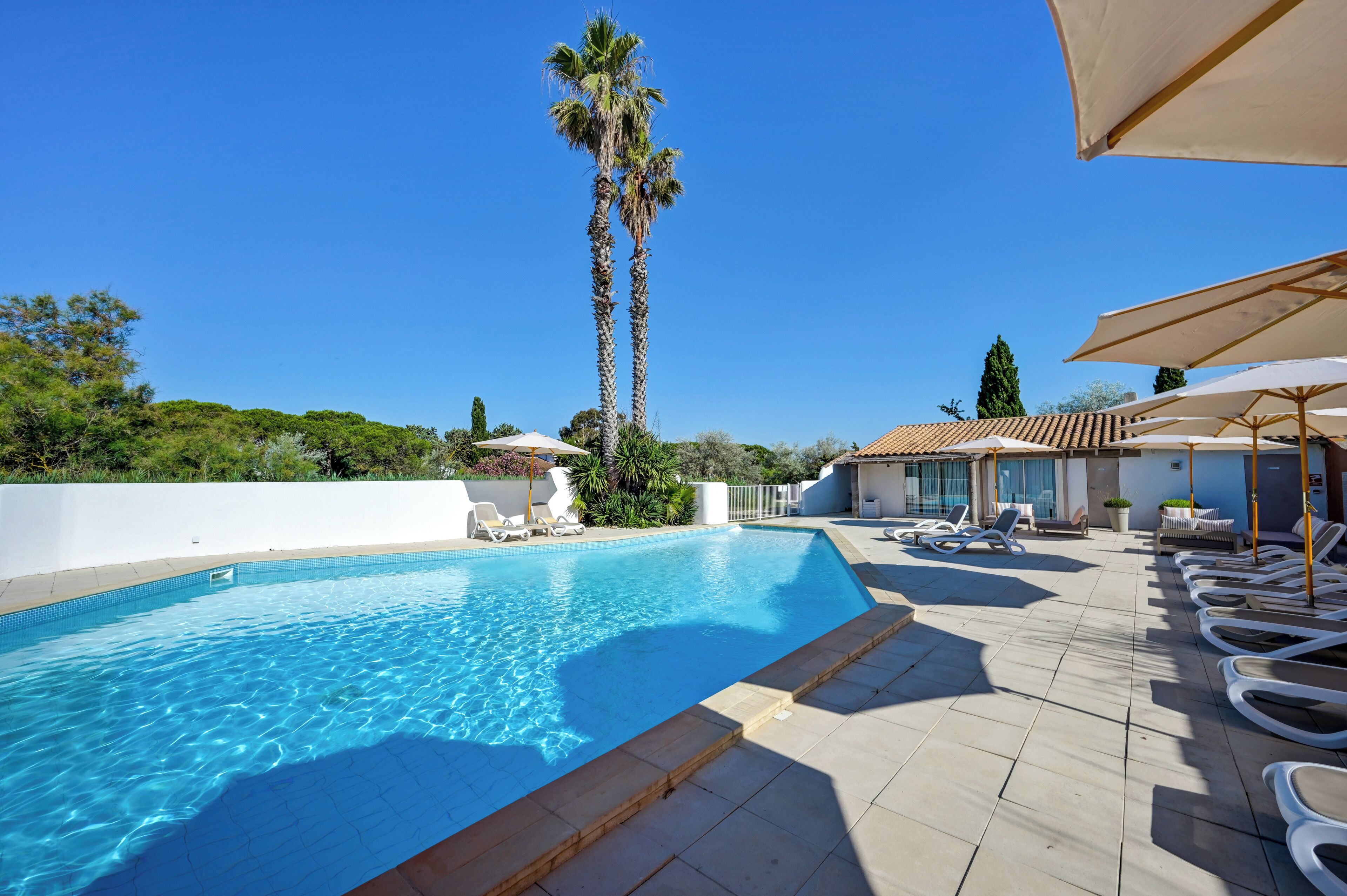 Seasonal outdoor pool, open 10:00 AM to 7:30 PM, pool umbrellas