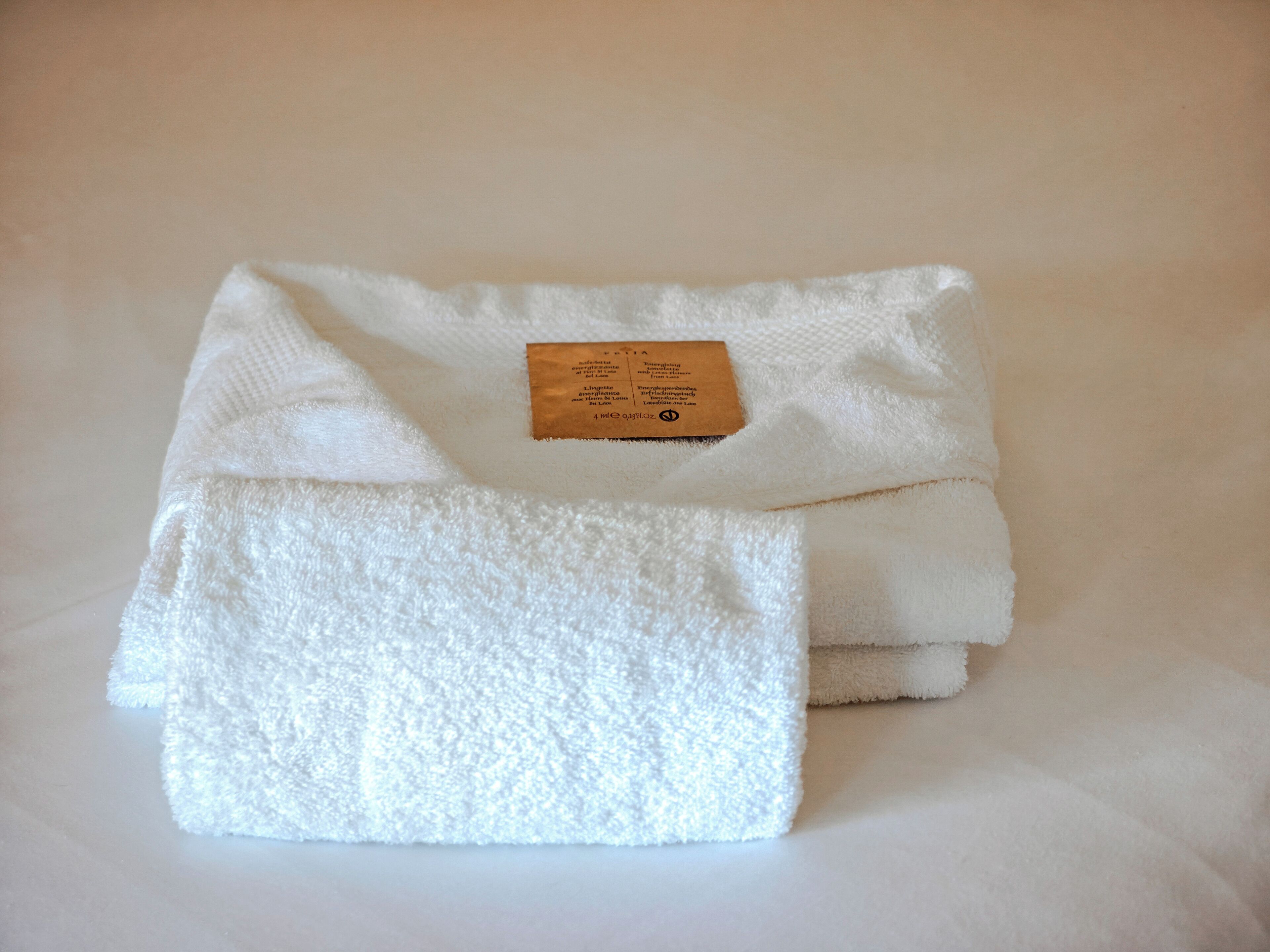 A folded white towel with a label.