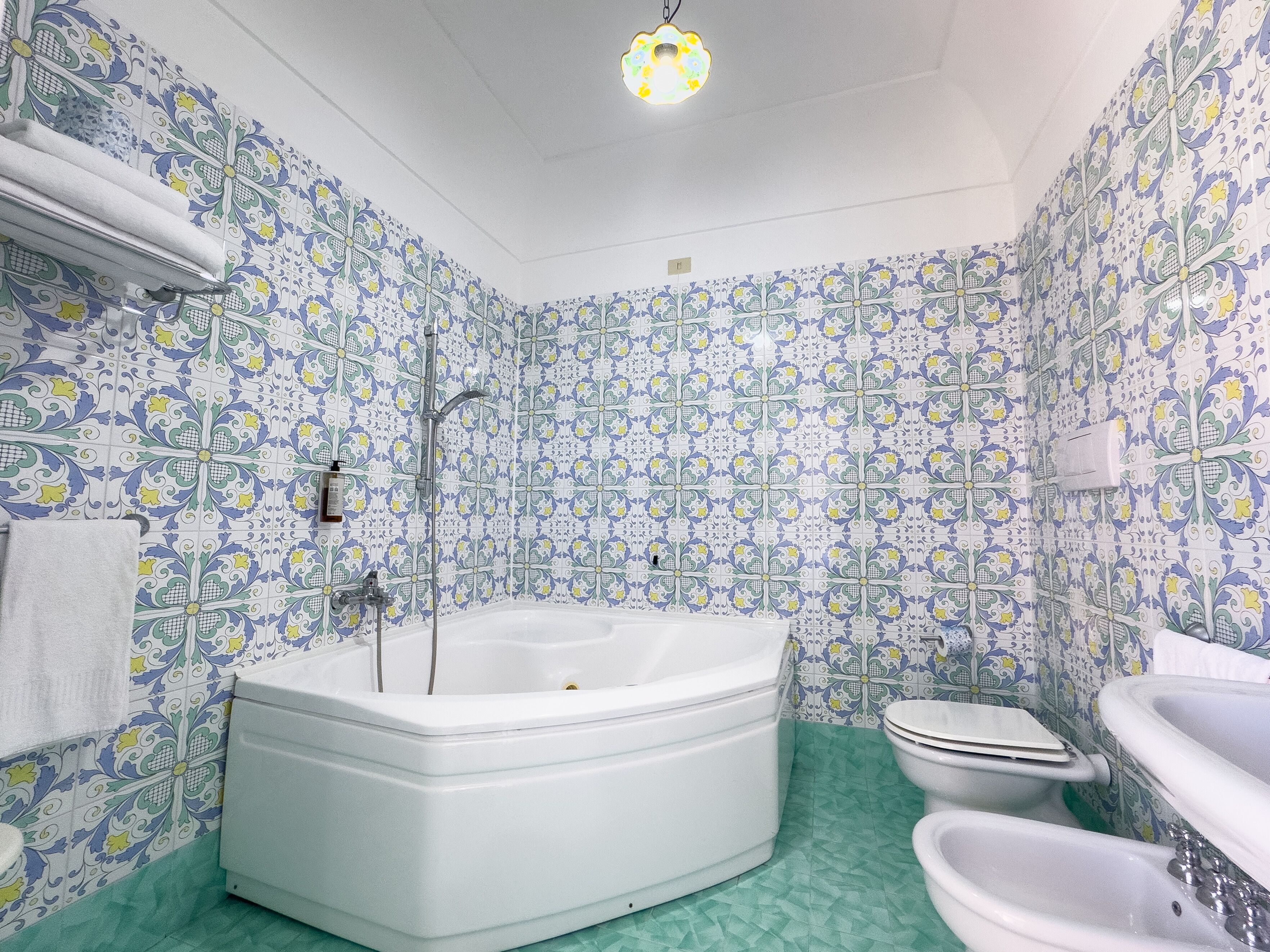 A bathroom with a bathtub, toilet, and sink, all with white fixtures.
