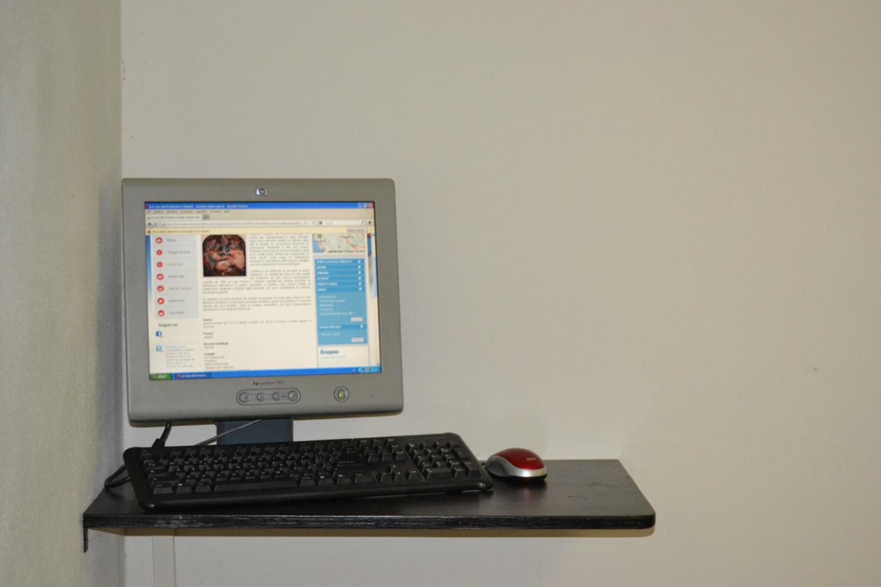 A desktop computer with a monitor, keyboard, and mouse on a desk.
