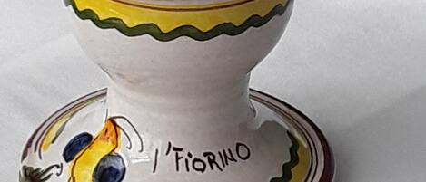 A ceramic candle holder with a bird design and the inscription "I'FIORINO".