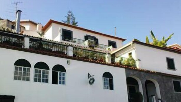 A multi-story building with a white facade, multiple windows, and balconies. - Pensão Residencial Vila Teresinha (Funchal)