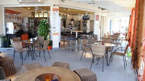 An indoor seating area with wicker furniture and a central round table.