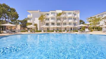 Relax by the pool surrounded by lounge chairs and umbrellas, with stunning views from the hotel's spacious balconies.