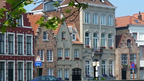 A historic building with a sign for Hotel Ter Duinen, featuring classic European architecture with a prominent entrance and multiple windows. - Ter Duinen (Bruges)