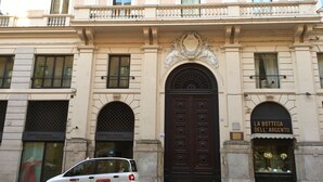 A building with a large, ornate entrance door, a sign reading "LA Bottega DELL'ARGENTO," and a white car parked in front. - Best Pantheon B&B (Rome)