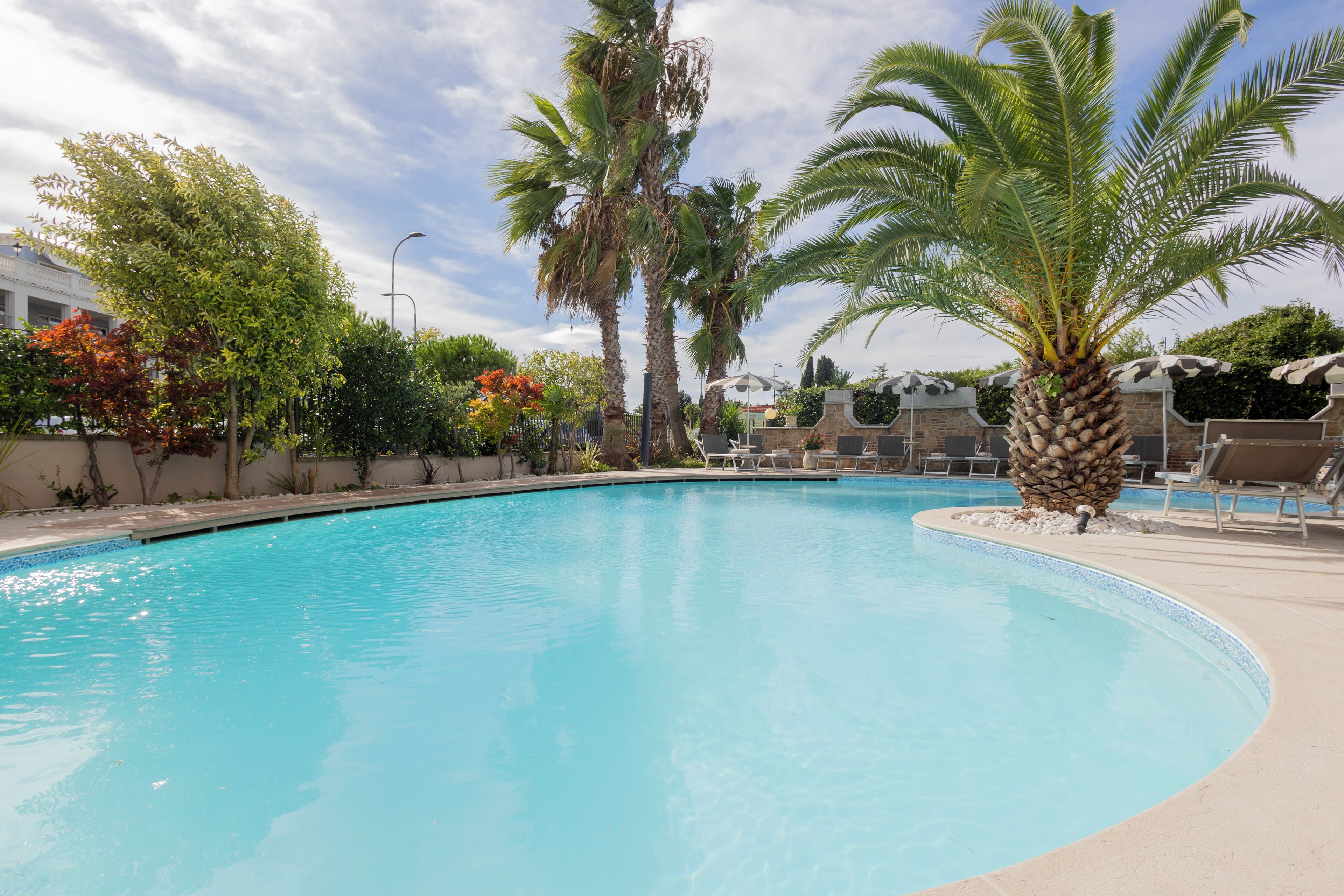 outdoor pool, open 9:00 am to 8:00 pm, pool umbrellas, pool loungers