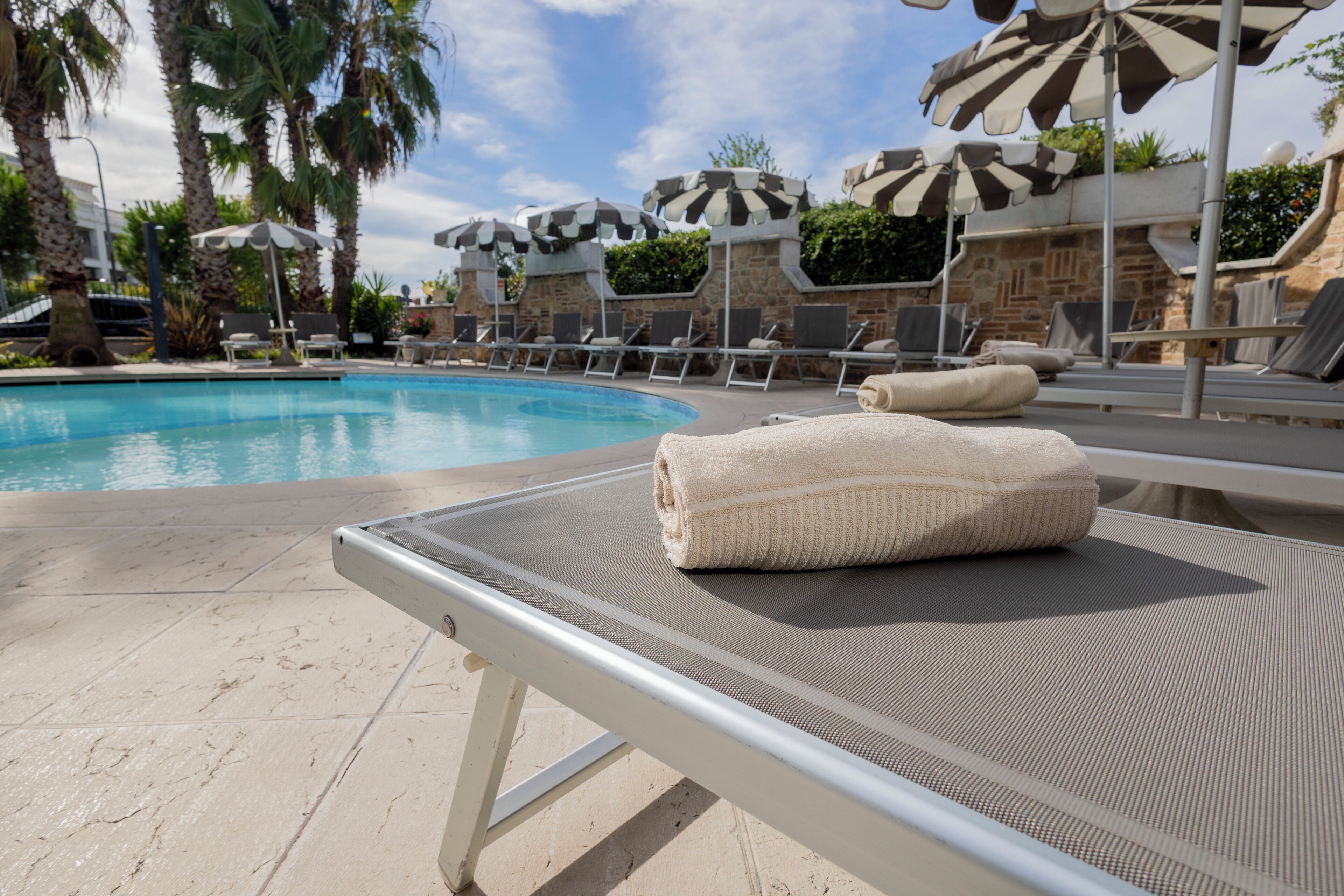 outdoor pool, open 9:00 am to 8:00 pm, pool umbrellas, pool loungers