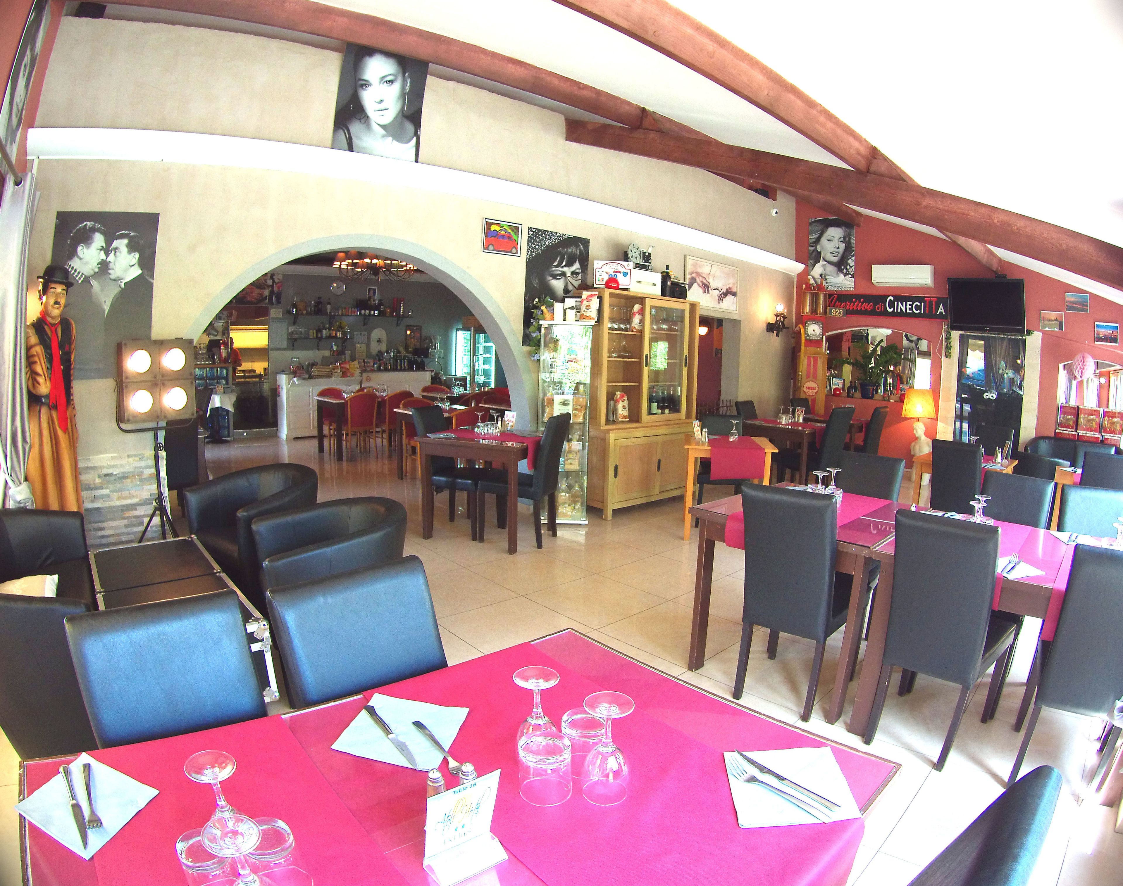 A restaurant with multiple tables and chairs, a bar area, and a visible menu board.
