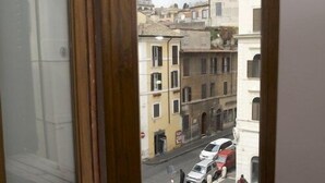 A window with a view of a street and buildings. - B&B SubUrbe Roma (Rome)