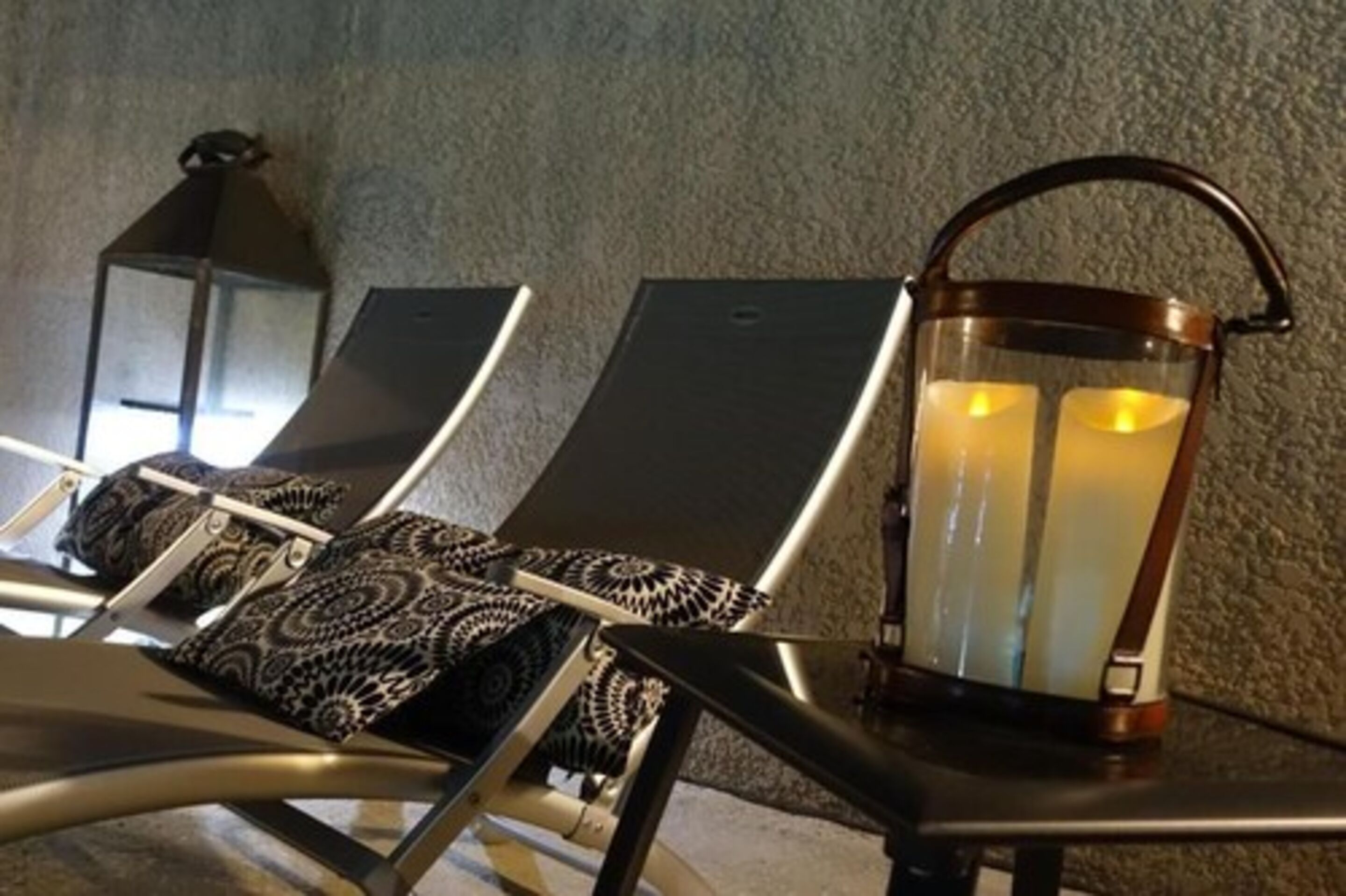 A lounge area with reclining chairs and a lantern.