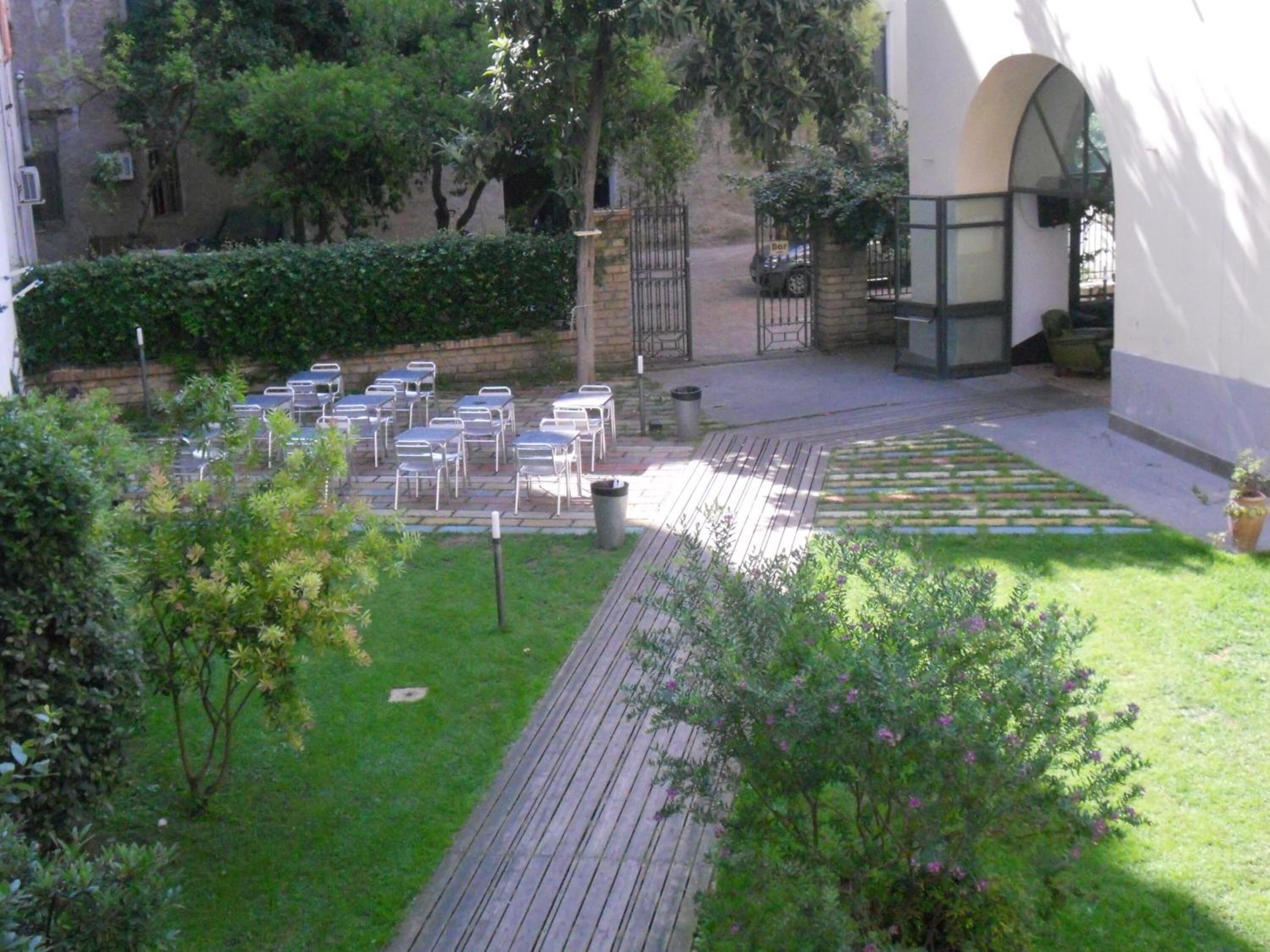 A courtyard with outdoor seating and a paved walkway.