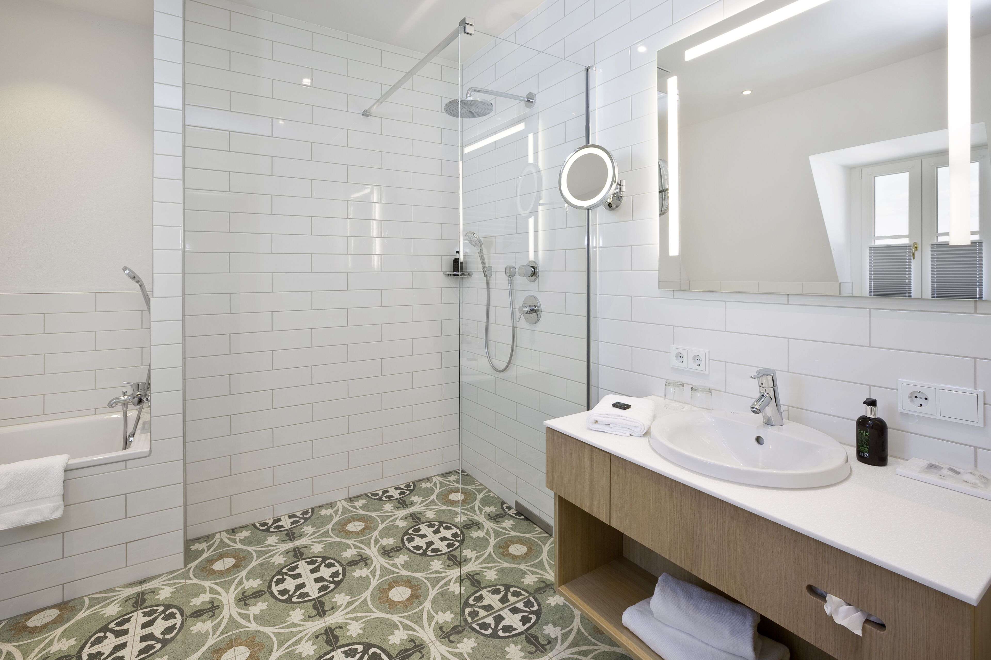 A modern bathroom with a shower, a bathtub, a sink, and a vanity.