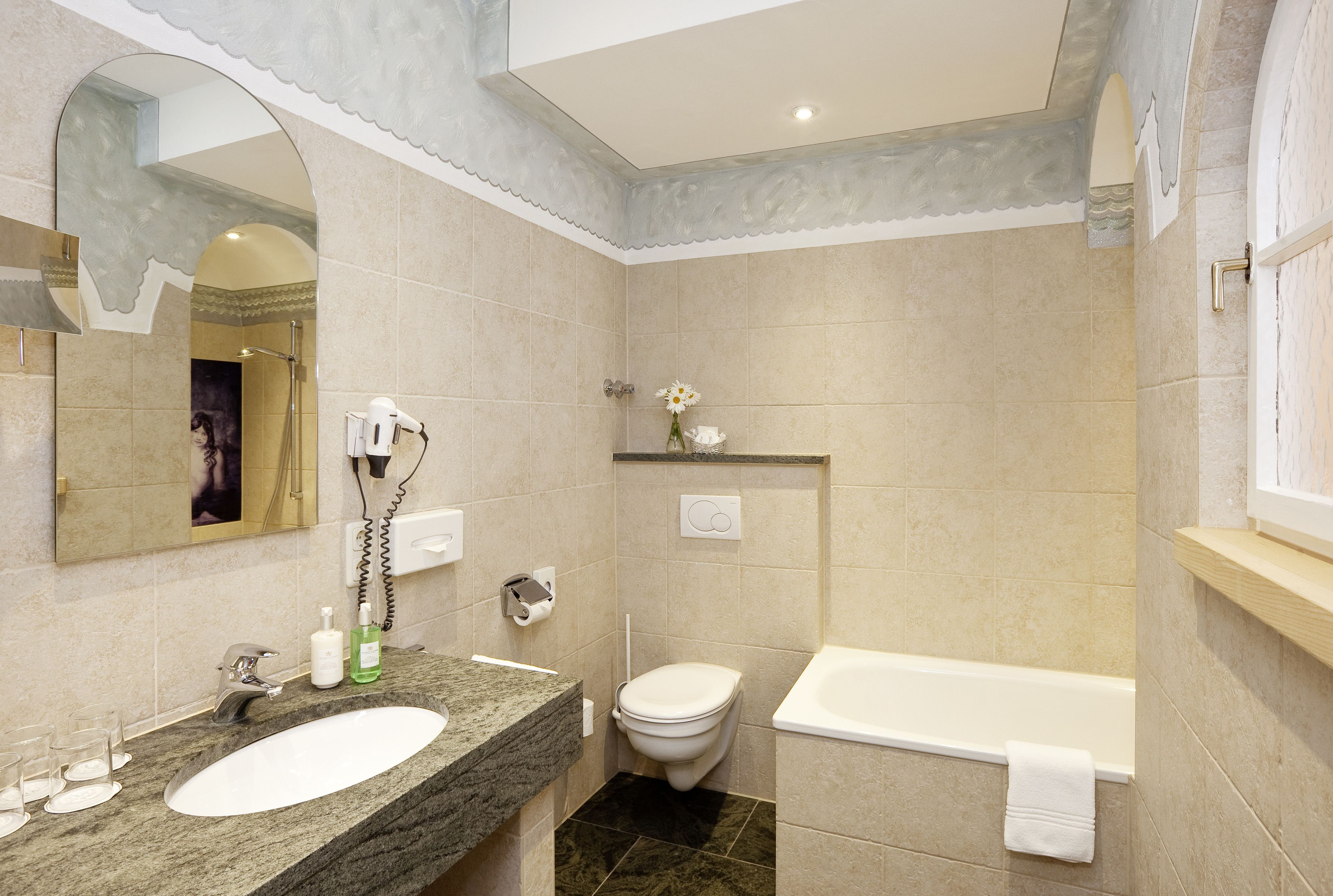 A bathroom with a sink, toilet, and bathtub.