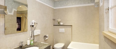 A bathroom with a sink, toilet, and bathtub.