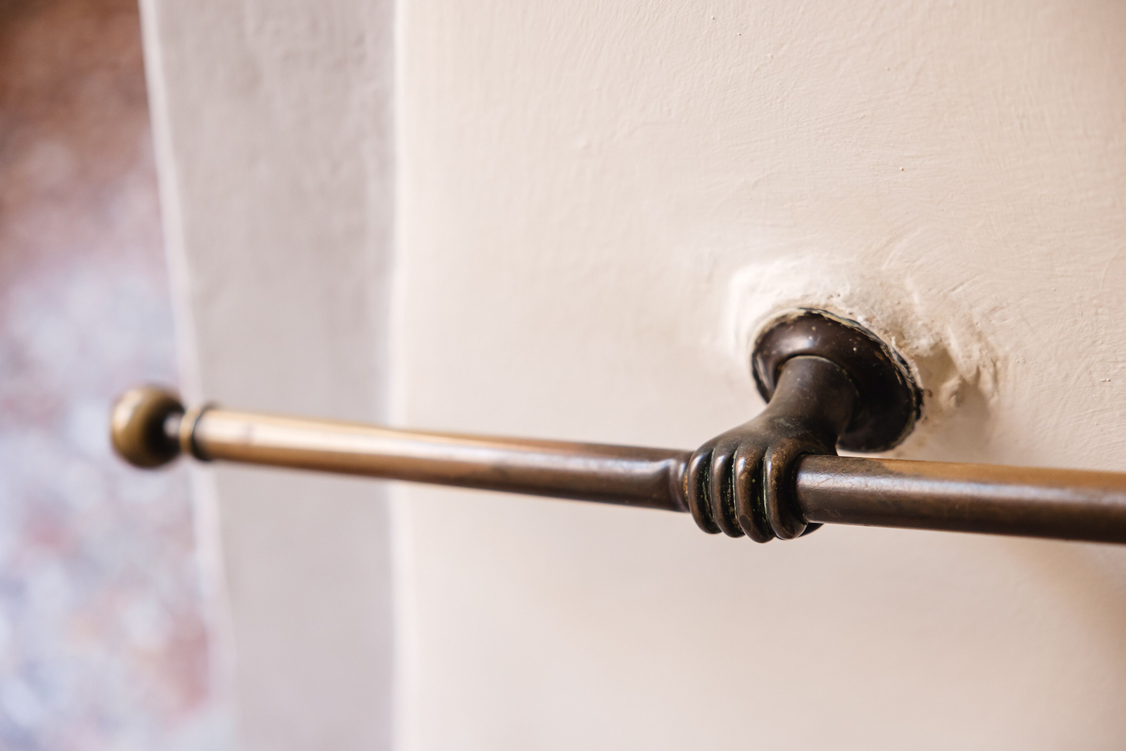A brass door handle on a white door.