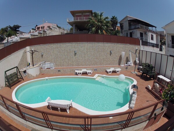 Seasonal outdoor pool, open 9 AM to 7 PM, pool umbrellas, pool loungers