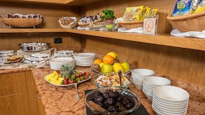 A buffet with various food items including fruits, nuts, and pastries. - West Point Airport Hotel (Villafranca di Verona)