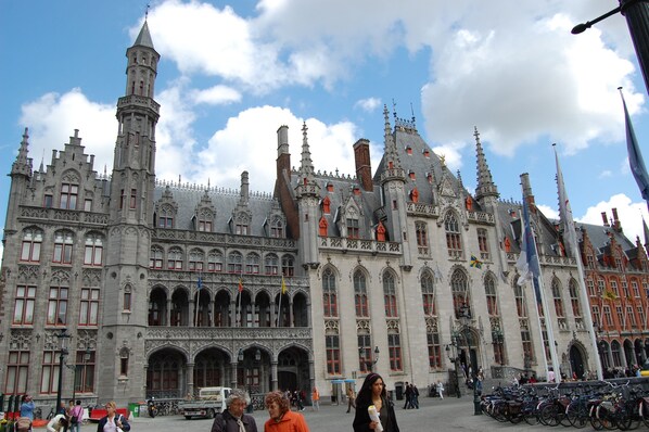 A historic building with intricate architecture and a large open plaza.