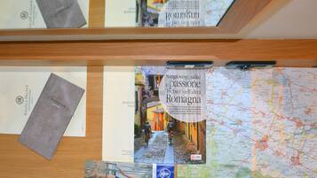 A wooden display with brochures, a map, and a sign for a hotel.