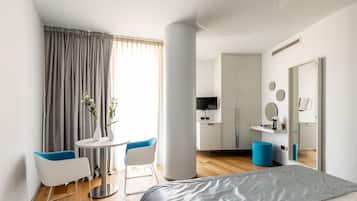 Deluxe Suite | Living area | 30-inch flat-screen TV with digital channels