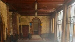 A spacious hallway with a patterned floor, large windows, and a wooden ceiling. - CSI Group - Hotel Central Station (Milan)