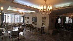 A spacious hotel lobby with multiple seating areas, chandeliers, and a large window with curtains. - Hotel Grand Liza (Istanbul)