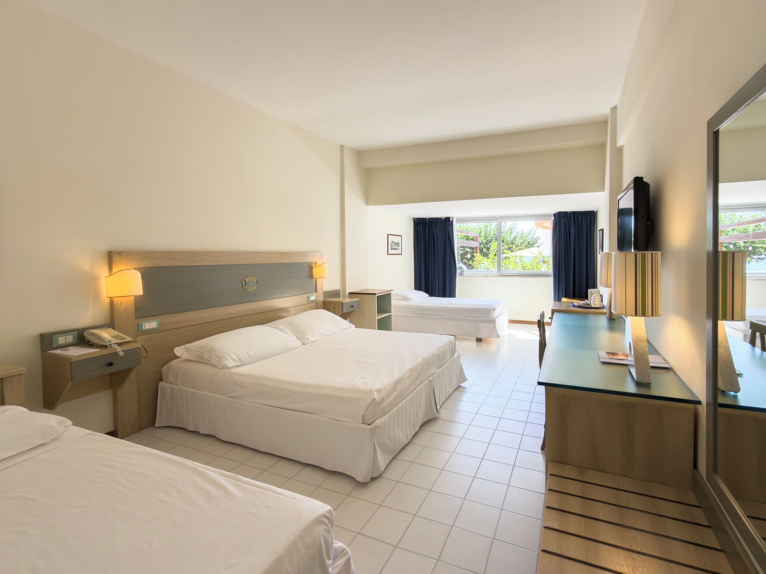 Economy Quadruple Room, 1 Bedroom | Minibar, in-room safe, desk, laptop workspace