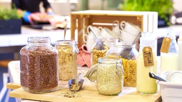 A variety of food items in jars and containers on a wooden table.