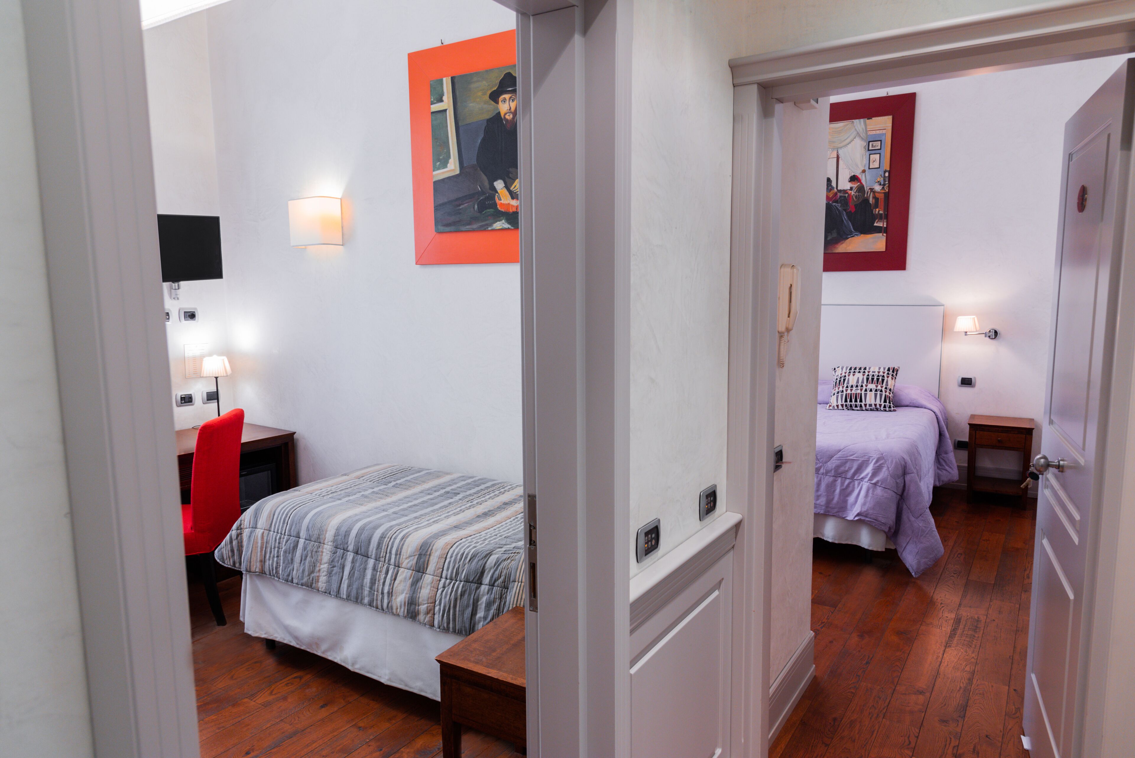 A hotel room with a bed, a desk, a chair, and two bedside tables.