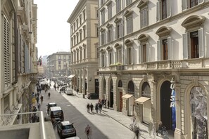 A street view of a historic building with multiple storefronts, including a visible 'LISA' sign. - Il Salotto di Firenze (Florence)
