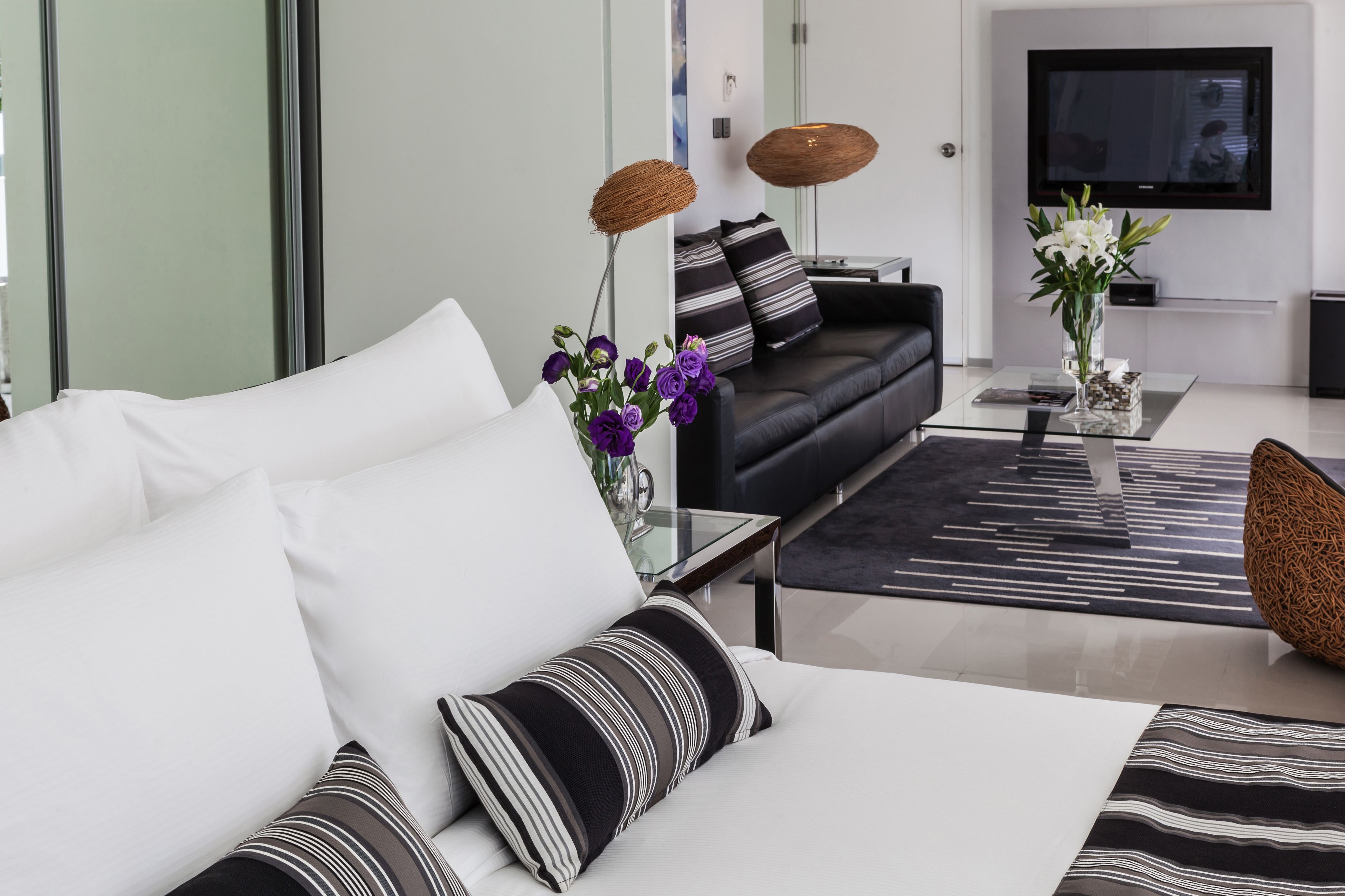 A modern living room with a sofa, coffee table, and decorative items.