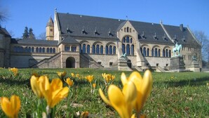 Ein historisches Gebäude mit einem markanten Eingang und einer Statue eines Reiters.