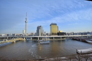 A river with a bridge, a tower, and modern buildings in the background. - Dormy Inn Express Asakusa Hot Spring (Tokyo)