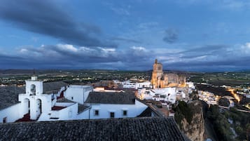 A historic town with a prominent church and white buildings with tiled roofs.