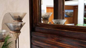 A wooden door with a mirror reflecting three glass objects.