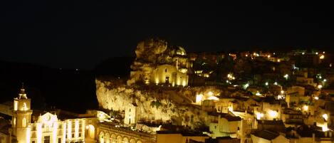 A historic town with a prominent church and a large rock formation.
