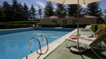 Seasonal outdoor pool, open 11:30 AM to 8:30 PM, pool umbrellas