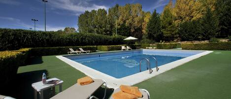 Seasonal outdoor pool, open 11:30 AM to 8:30 PM, pool umbrellas