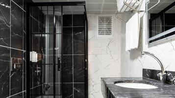 Shower, hair dryer, slippers, towels